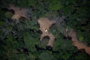108756945-files-aerial-view-showing-a-bulldozer-removing-wood-from-a-deforested-area-in-the-amaz